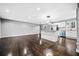 Open-concept space with hardwood floors, featuring a kitchen with white cabinets, stainless steel appliances, and a peninsula at 2814 Lloyd Rd, Decatur, GA 30034