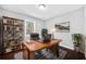 Home office with built-in shelving, wooden desk, and a comfortable workspace at 2814 Lloyd Rd, Decatur, GA 30034