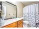 Functional bathroom featuring a toilet, shower with curtains, sink, and vanity at 3068 Cedar Glade Ln, Buford, GA 30519
