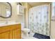 Bathroom with a vanity, toilet, mirror, and a shower with a curtain at 3068 Cedar Glade Ln, Buford, GA 30519