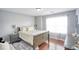 Bedroom featuring a bed, dresser, window with curtains, rug, and wall decor at 3068 Cedar Glade Ln, Buford, GA 30519