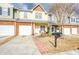 Charming townhome featuring a well-manicured front yard and attached one car garage at 3068 Cedar Glade Ln, Buford, GA 30519