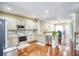 Stylish kitchen with stainless appliances, granite countertops, and open layout to living area at 3068 Cedar Glade Ln, Buford, GA 30519