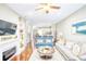Open-concept living room featuring a fireplace, hardwood floors, and an adjacent kitchen at 3068 Cedar Glade Ln, Buford, GA 30519
