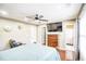 Bright main bedroom featuring large TV, dresser and ensuite bathroom at 3068 Cedar Glade Ln, Buford, GA 30519
