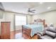 Spacious main bedroom with a ceiling fan, a recliner, and hardwood floors at 3068 Cedar Glade Ln, Buford, GA 30519
