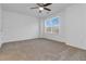 Bright bedroom featuring neutral carpet, large window, and ceiling fan at 3541 Parc Sw Cir, Atlanta, GA 30311