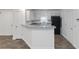 Modern kitchen with granite countertops, white cabinets, breakfast bar, and black appliances at 3541 Parc Sw Cir, Atlanta, GA 30311