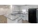 Well-lit kitchen with granite counters, white cabinets, and black refrigerator at 3541 Parc Sw Cir, Atlanta, GA 30311