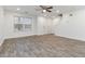 Bright, spacious living room featuring modern flooring, white walls, ceiling fan, and ample natural light at 3541 Parc Sw Cir, Atlanta, GA 30311