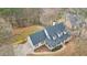 Aerial view of a charming home with a well-manicured lawn and a picturesque setting surrounded by mature trees at 3773 Galdway Dr, Snellville, GA 30039