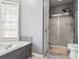 Bright bathroom featuring a tub, shower, and ample natural light at 3773 Galdway Dr, Snellville, GA 30039