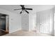 Neutral bedroom featuring neutral carpet, a ceiling fan, and three doors at 3773 Galdway Dr, Snellville, GA 30039