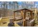 Outdoor deck featuring stylish patio furniture with neutral cushions under a gazebo and view of the wooded backyard at 3773 Galdway Dr, Snellville, GA 30039