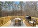 Wooden deck with outdoor dining furniture and a grill, perfect for entertaining and enjoying meals outdoors with a view at 3773 Galdway Dr, Snellville, GA 30039