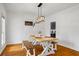 Bright dining area featuring modern décor, a farmhouse style table, and hardwood floors at 3773 Galdway Dr, Snellville, GA 30039