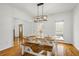 Well-lit dining space with a farmhouse table, modern lighting, and views to the front yard at 3773 Galdway Dr, Snellville, GA 30039