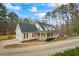Traditional home featuring a welcoming front porch, attached garage, and beautiful curb appeal at 3773 Galdway Dr, Snellville, GA 30039