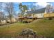 A lovely home exterior displaying a deck, gazebo, and landscaped lawn in a serene, verdant backyard setting at 3773 Galdway Dr, Snellville, GA 30039