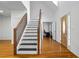 Bright foyer featuring hardwood floors, a staircase, and a glimpse of an office space beyond the doorway at 3773 Galdway Dr, Snellville, GA 30039