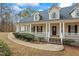 Inviting home featuring a spacious front porch, columns, a well-manicured lawn, and a welcoming entrance at 3773 Galdway Dr, Snellville, GA 30039