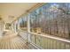 Long porch with wooden flooring and railings showcasing the serene backyard and offering a relaxing outdoor space at 3773 Galdway Dr, Snellville, GA 30039