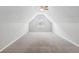 The attic features carpet, a small window, and slanted walls at 4710 Vineyard Se Ct, Smyrna, GA 30082