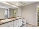 Bathroom with double sinks, white cabinets, and a large mirror at 4710 Vineyard Se Ct, Smyrna, GA 30082
