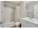 Cozy bathroom features a shower-tub combination with stylish white cabinets and complementary fixtures at 4710 Vineyard Se Ct, Smyrna, GA 30082