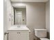 Bathroom with white vanity, toilet, mirror and neutral paint at 4710 Vineyard Se Ct, Smyrna, GA 30082
