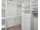 This walk-in closet has custom shelving to efficiently store all your clothes and accessories at 4710 Vineyard Se Ct, Smyrna, GA 30082
