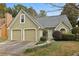 Charming home featuring a two-car garage and lush front yard landscaping at 4710 Vineyard Se Ct, Smyrna, GA 30082
