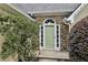 Close-up of front door with stone accent wall and green door at 4710 Vineyard Se Ct, Smyrna, GA 30082