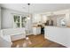 Bright eat-in kitchen boasts white cabinets, a breakfast nook with bench seating, and stainless steel appliances at 4710 Vineyard Se Ct, Smyrna, GA 30082
