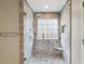 The shower features tile walls, a built-in bench, window and a shower head with complementary fixtures at 4710 Vineyard Se Ct, Smyrna, GA 30082