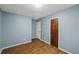 Bedroom features wood-look flooring, and neutral walls at 1057 Forest Path, Stone Mountain, GA 30088