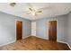Bedroom features wood-look flooring, ceiling fan, and neutral walls at 1057 Forest Path, Stone Mountain, GA 30088
