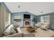Staged living room featuring a fireplace, vaulted ceilings, and neutral-toned furniture and decor at 1057 Forest Path, Stone Mountain, GA 30088