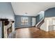 Spacious living room featuring a fireplace, wood-look flooring, and stairs to the second story at 1057 Forest Path, Stone Mountain, GA 30088