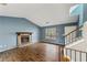 Open living room with fireplace, wood-look flooring, and stairs to the second story at 1057 Forest Path, Stone Mountain, GA 30088