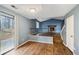 Open living area with a vaulted ceiling, stone fireplace, and wood-look flooring at 1057 Forest Path, Stone Mountain, GA 30088