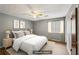 Bedroom with ceiling fan, wood-look flooring, and large window at 1057 Forest Path, Stone Mountain, GA 30088