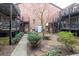 Cozy outdoor courtyard with stone pavers, lush greenery, and wrought-iron balconies for a tranquil setting at 3091 Colonial Way # D4, Atlanta, GA 30341