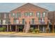 Charming brick townhouses feature balconies, green shutters, and well-manicured landscaping creating curb appeal at 3091 Colonial Way # D4, Atlanta, GA 30341