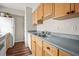 Well-lit kitchen featuring wood-look flooring, gray countertops, and sufficient cabinet space at 3091 Colonial Way # D4, Atlanta, GA 30341