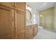 Modern bathroom with wood cabinets, a glass shower, and white tile floors at 1137 Hardee Ne St # A, Atlanta, GA 30316