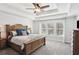 Spacious main bedroom featuring tray ceiling, large bed, and generous windows at 1938 Gotham Ne Way, Atlanta, GA 30324