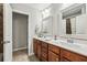 Bright bathroom features double vanity with tile floors and updated fixtures at 4240 Hunters Walk Way, Cumming, GA 30028