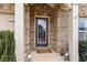 Close-up of the home's entrance with decorative lanterns, and a brick surround, offering a welcoming and stylish entryway at 4240 Hunters Walk Way, Cumming, GA 30028