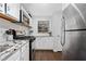 Well-lit kitchen features stainless steel appliances, granite countertops, and white subway tile backsplash at 801 Cumberland Se Ct, Smyrna, GA 30080